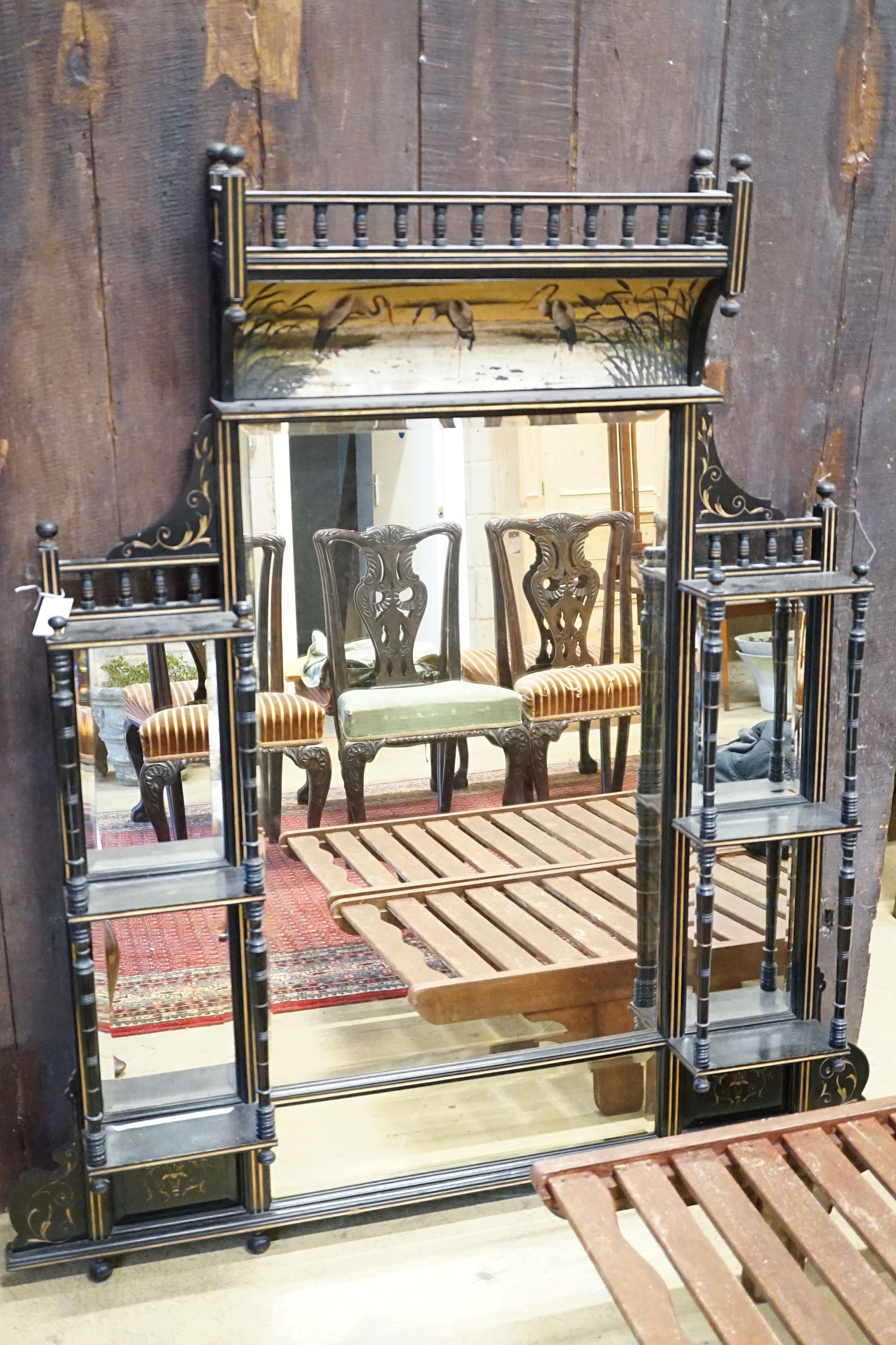 A late Victorian Aesthetic Movement parcel gilt ebonised overmantel mirror, width 134cm, height 153cm